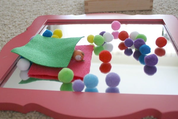 Toddler Activity: Invitation to play with pom poms and mirror