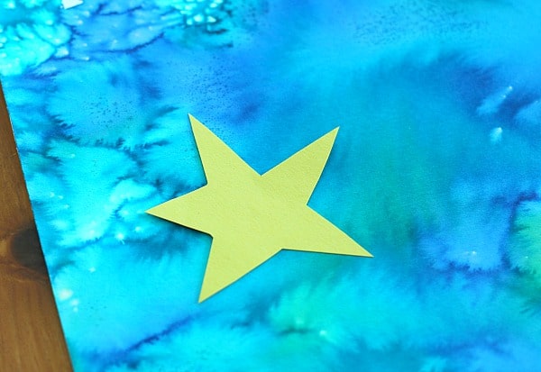 glue yellow star onto watercolored paper