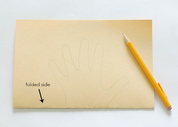 trace your hand on the folded paper