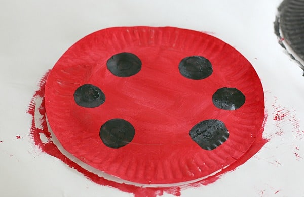 paint black circles onto the red plate