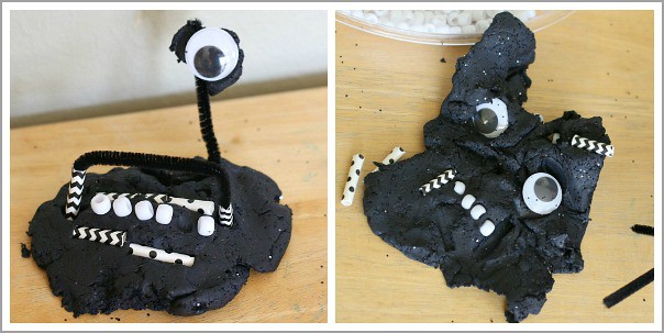 playing with black playdough and loose parts