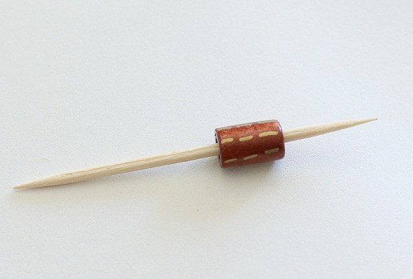 use a toothpick to hold the bead