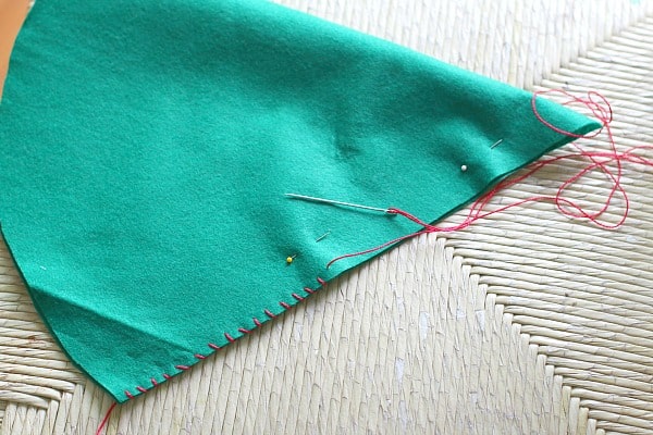 use a whip stitch to sew up the seam in your felt elf hat