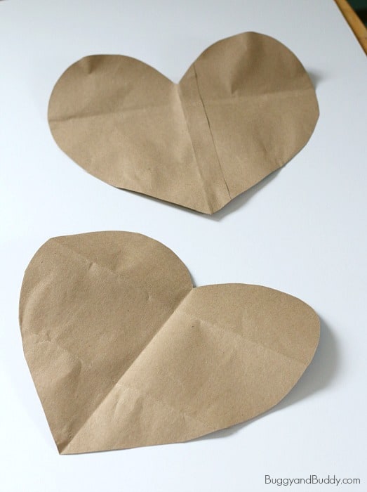 cut out two large hearts from a large brown paper bag