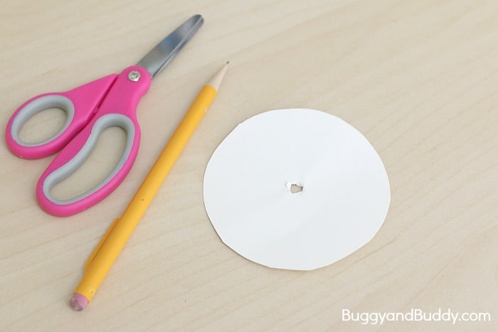 poke a hole in your paper circle