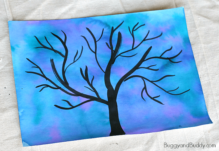 paint a black tree silhouette over the watercolor background