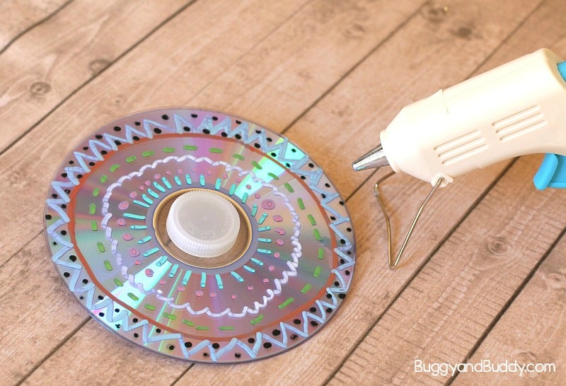 glue a plastic top to your CD to make a spinning top toy for kids