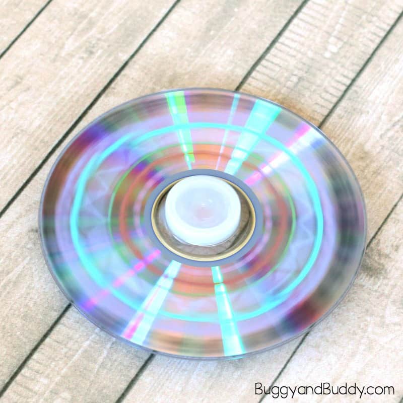 Science STEM for Kids: Explore physics with this easy spinning top craft for kids using a CD and marble