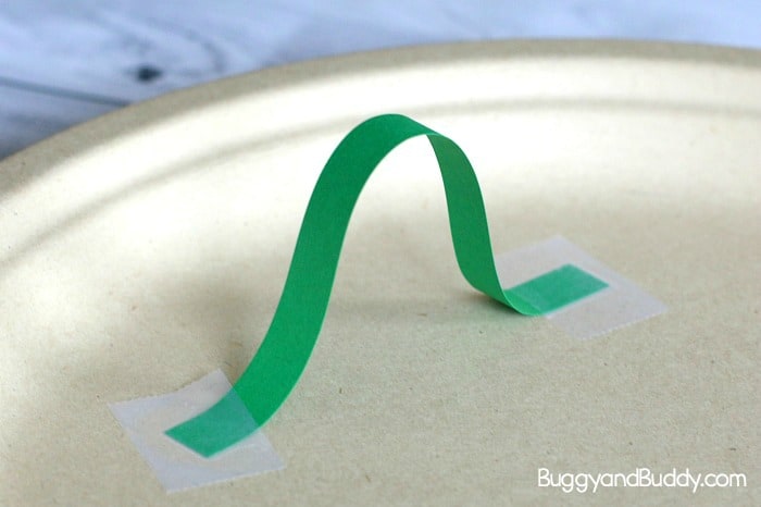 make a paper plate marble maze using strips of construction paper