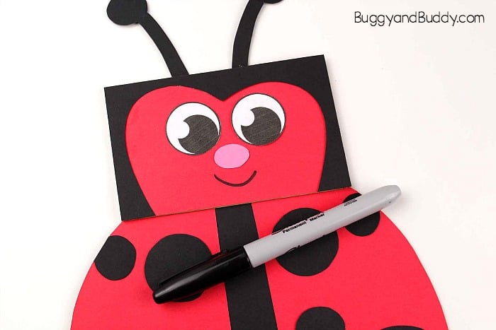 add a nose and mouth to your ladybug paper bag puppet craft for kids